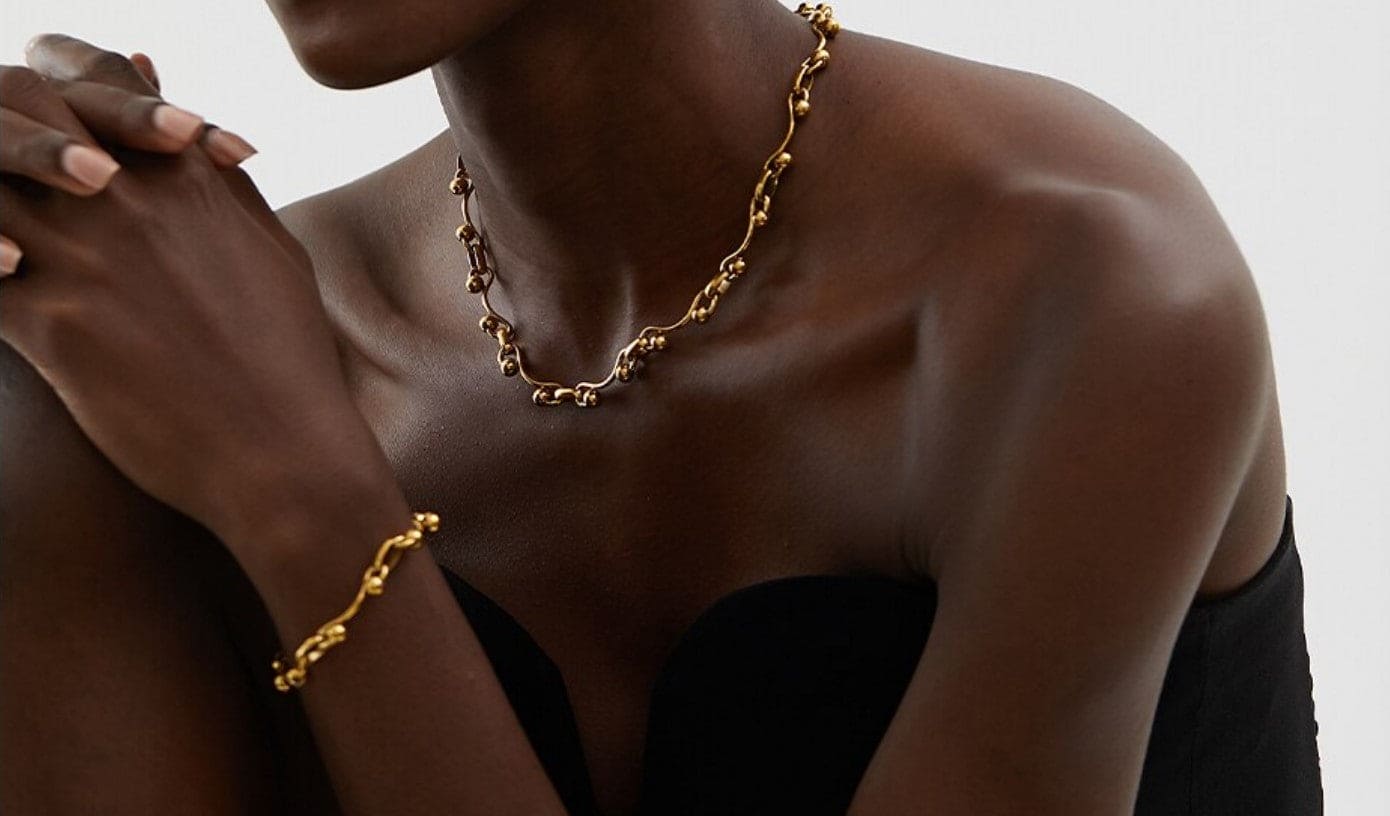 Lady wearing gold ball Yvette necklace
