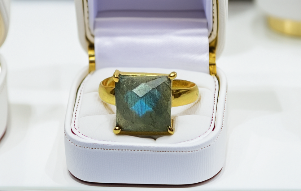 Luxury handcrafted gemstone ring in elegant display box.