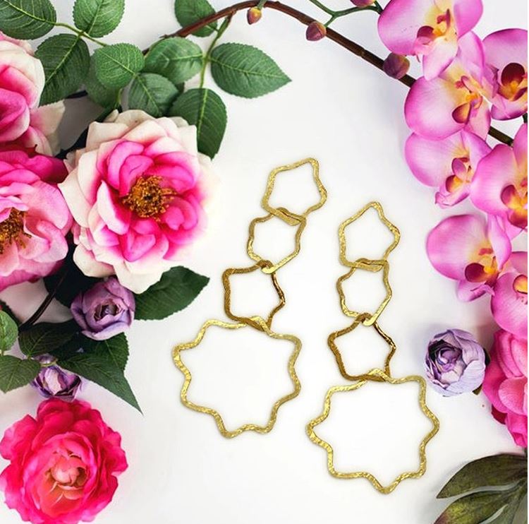 Gold Elegant Dangle Cassie ADMK Earrings with floral backdrop